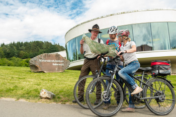 Cyclists with a ranger in front of the national park centre.